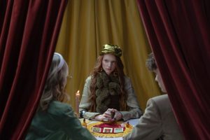 First psychic reading — A mysterious fortune teller reads tarot cards for a couple in a mystical setting.
