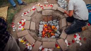 First kambo session — Traditional underground oven in Otavalo, Ecuador with vegetables and petals.